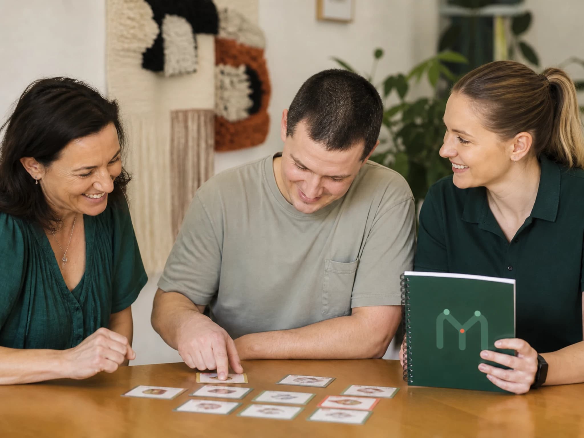 An adult, family member and behaviour support practitioner mapping an everyday home routine together