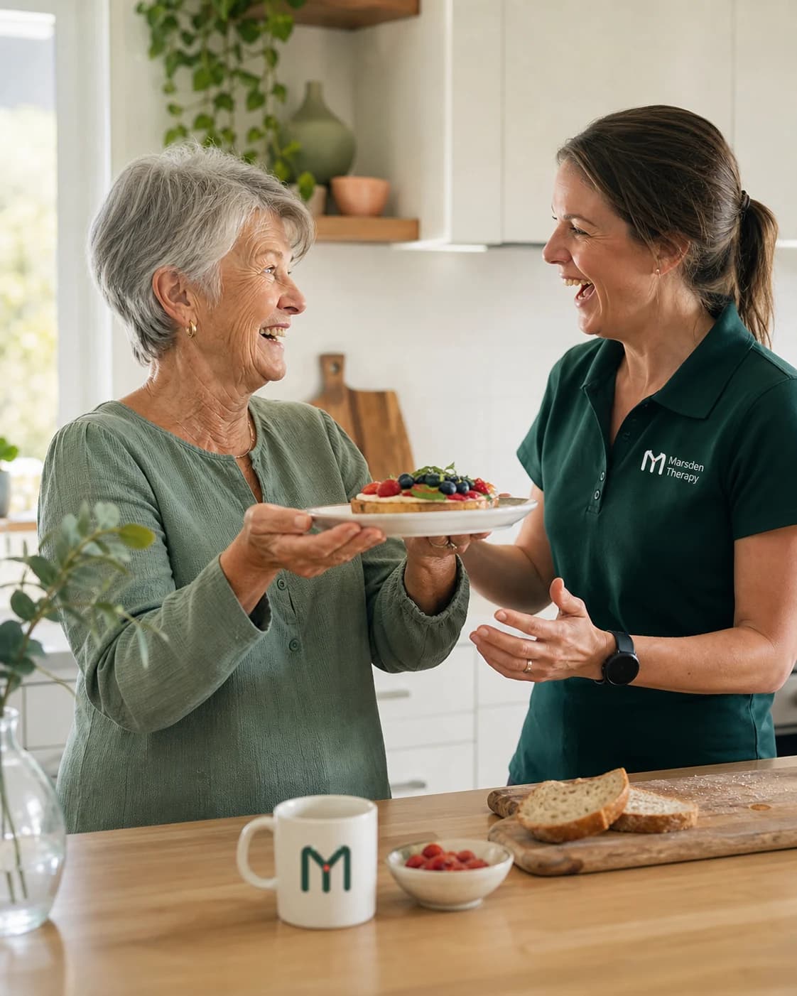 An older adult preparing food in a kitchen alongside an occupational therapist